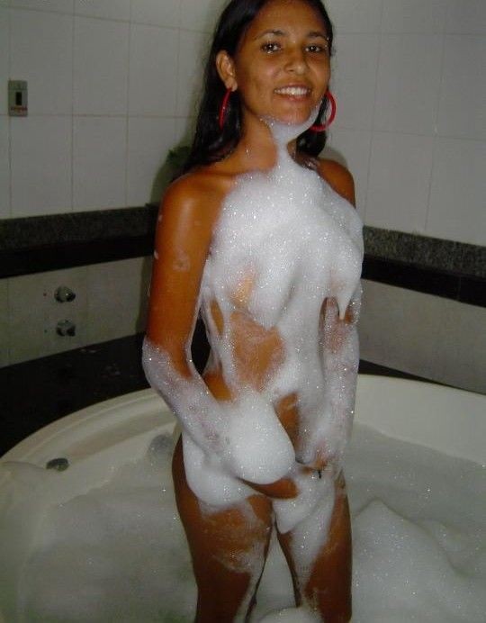 A naked Latina chick in bed and in the bathtub #77956404