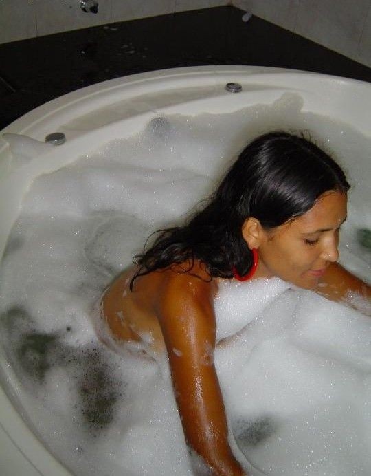 A naked Latina chick in bed and in the bathtub #77956416