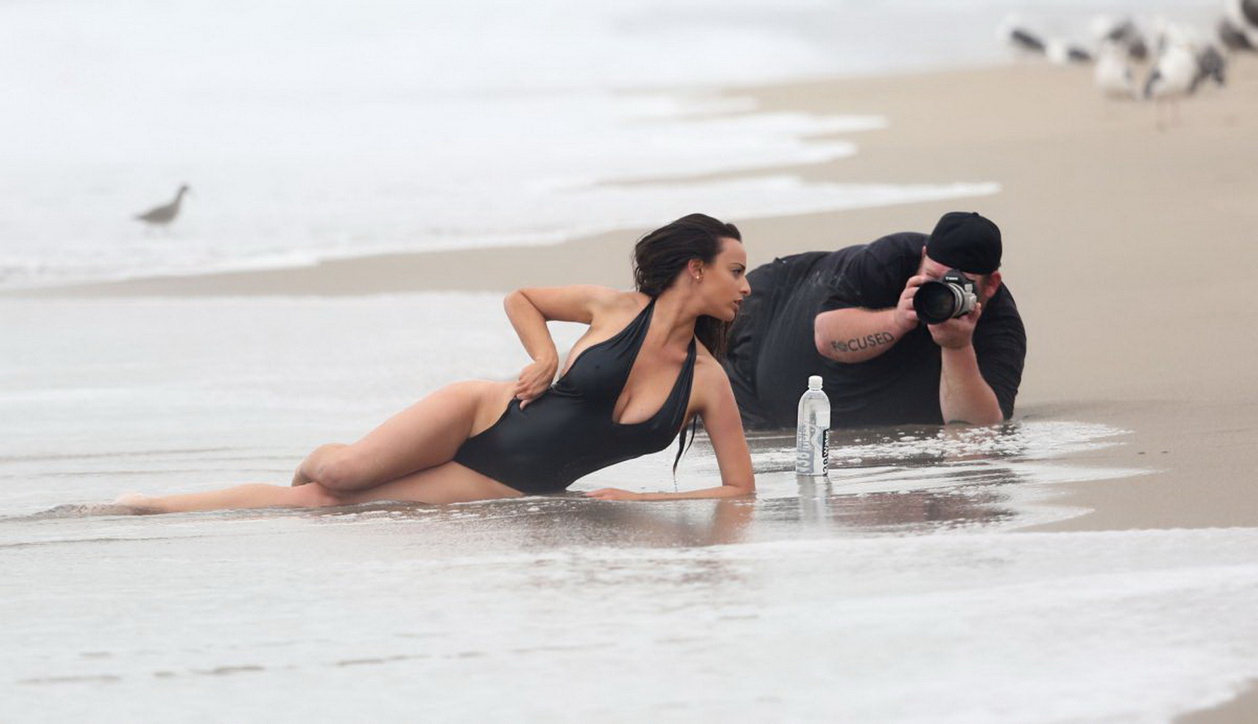 Kayla Swift shows sideboob and pokies in black swimsuit while freezing on the be #75177388