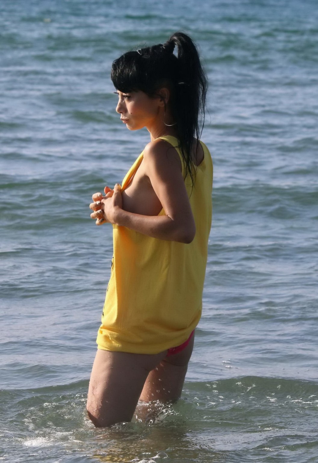 Bai Ling shows sideboob and pokies in wet tshirt and bikini bottom at the beach  #75179097