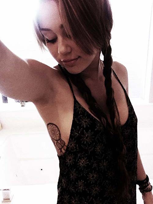 Miley Cyrus undressing her blouse and showing tits in bra #75276654