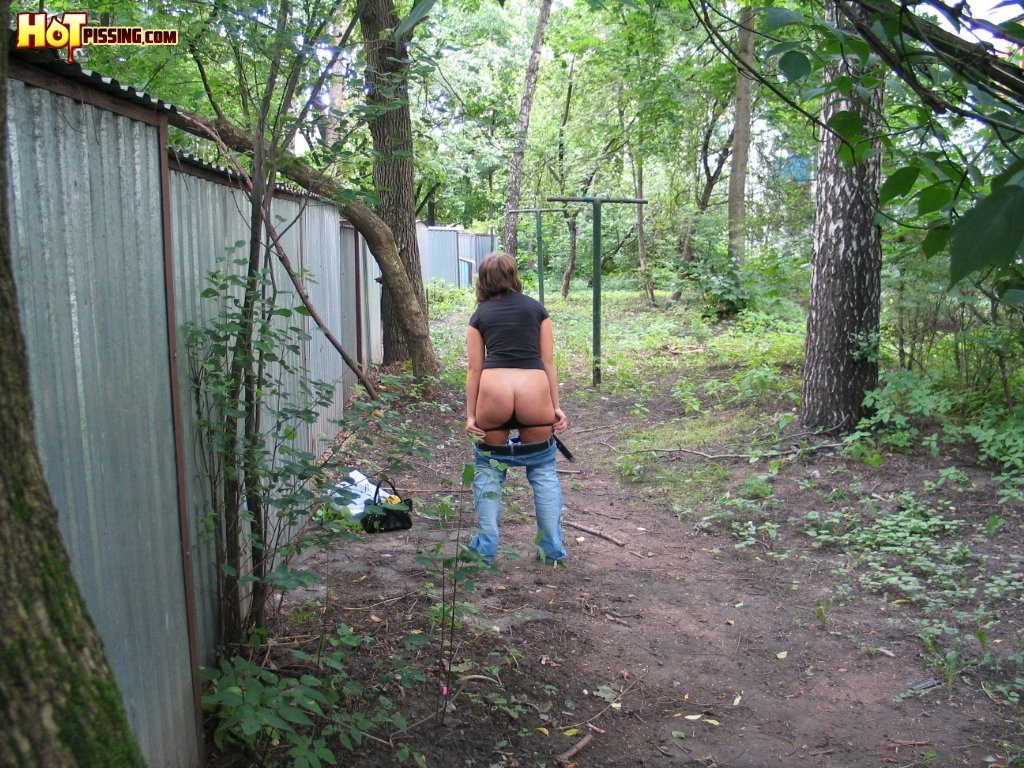 Spy camera shots of a gal in jeans as she does a leak behind a garage #76565079