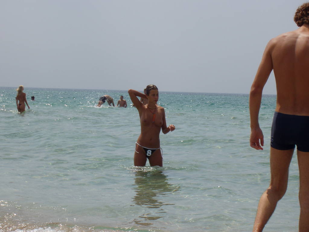 Young nudists rub oil on each other's naked bodies #72256490