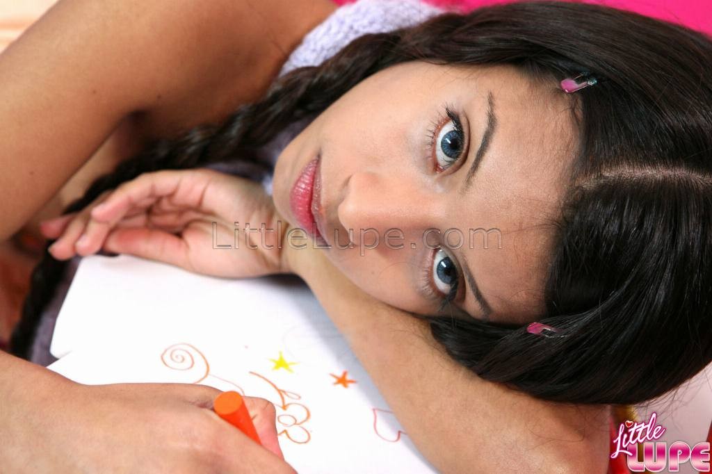 School girl little lupe with her hair braids doing homework #77968090
