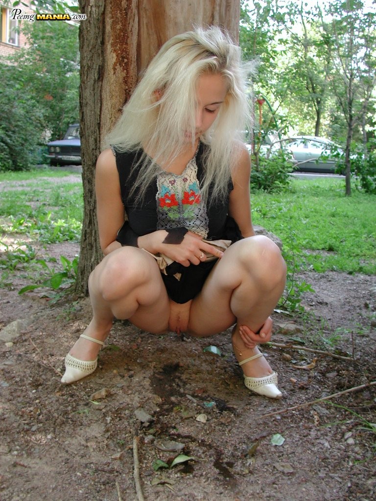 Pee-needed blonde squats behind a tree to relieve herself in the park #76566474